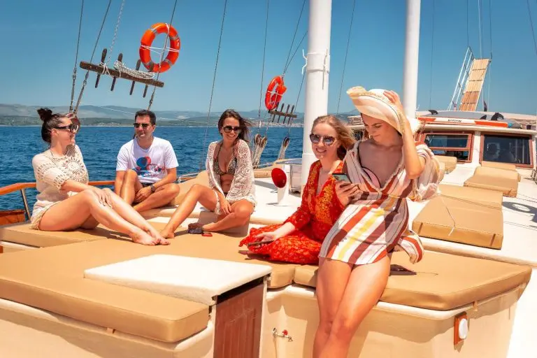 Young people in summer clothes on gulet cruise in Croatia